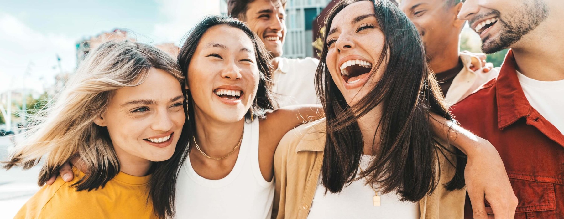 Friends Laughing Together Outdoors on a Sunny Day